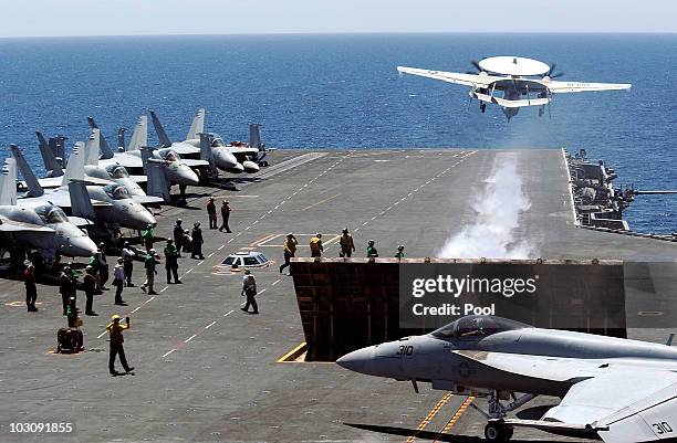 Fighter takes off from the flight deck of USS George Washington during a joint military exercises at east sea on July 26, 2010 in South Korea. The...