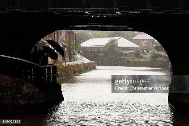 Walkers make their way along the towpath at Wigan Pier next to the Liverpool and Leeds canal on July 26, 2010 in Wigan, England. A section of the...