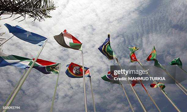 Flags representing some of the 30 different nations taking part in the 15th African Union Summit flutter at the entrance of the convention hall on...