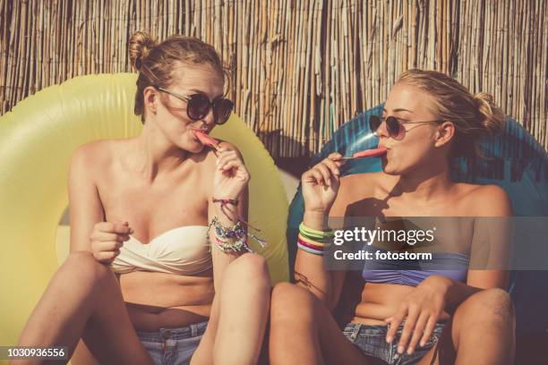 friends eating ice cream at the beach - messy hair bun stock pictures, royalty-free photos & images