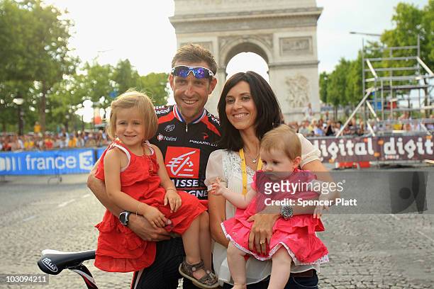 Christophe Moreau of team Caisse D'Epargne celebrates his final tour with his family after the twentieth and final stage of Le Tour de France 2010,...