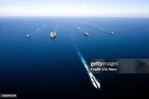 In this handout image provided by the U.S. Navy, U.S. Navy and South Korean ships sail in a 13-ship formation led by the Los Angeles-class attack...