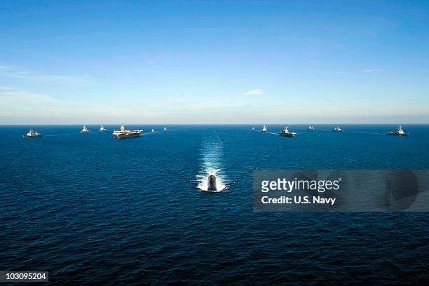 In this handout image provided by the U.S. Navy, U.S. Navy and South Korean ships sail in a 13-ship formation led by the Los Angeles-class attack...