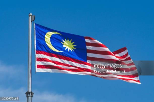 malaysia's flag  namely "jalur gemilang" for malaysian waving over cloudy day in kuala lumpur - malaysia flag stock pictures, royalty-free photos & images