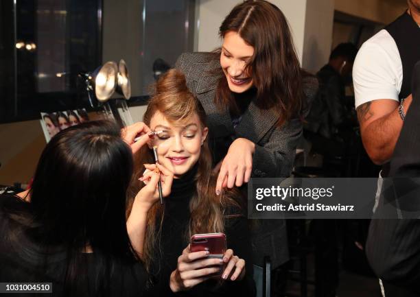 Models Gigi Hadid and Bella Hadid prepare backstage for the Anna Sui show during New York Fashion Week: The Shows at Gallery I at Spring Studios on...