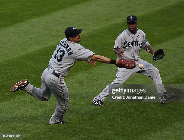 Casey Kotchman of the Seattle Mariners drops the ball on a hit by Carlos Quentin of the Chicago White Sox as teammate Chone Figgins moves in at U.S....
