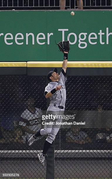 Ichiro Suzuki of the Seattle Mariners leaps high to rob Mark Kotsay of the Chicago White Sox of a home run in the 6th inning at U.S. Cellular Field...