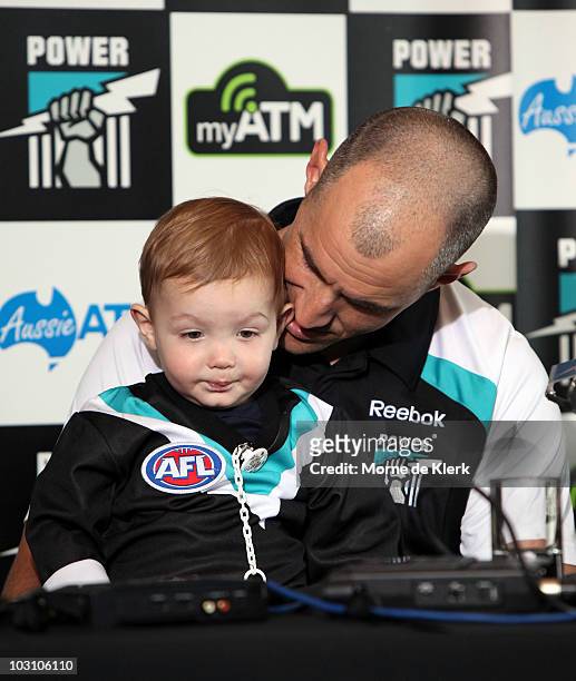 Warren Tredrea of the Port Adelaide Power talks to the media with his son, Nate, as he announces his AFL retirement at the Port Adelaide headquarters...