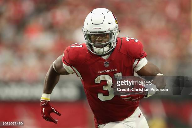 Running back David Johnson of the Arizona Cardinals rushes the football against the Washington Redskins during the NFL game at State Farm Stadium on...