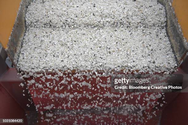 lithium ore falls through a separation machine - metal ore stock pictures, royalty-free photos & images