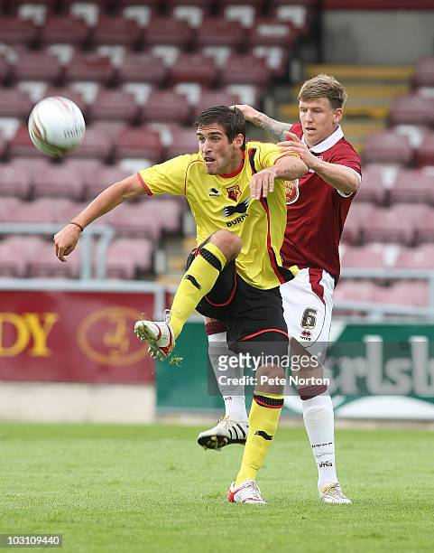 Danny Graham of Watford attempts to control the ball under pressure from Dean Beckwith of Northampton Town during the pre season match between...