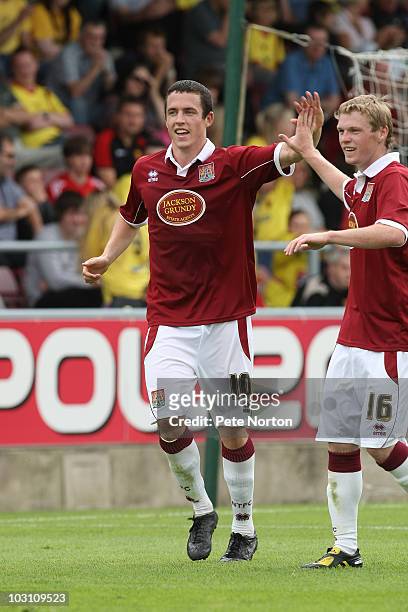 Tadhg Purcell of Northampton Town is congratulated by Billy McKay after scoring his sides third goal during the pre season match between Northampton...