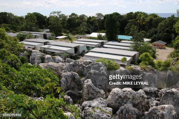 This photograph taken on September 2, 2018 shows a general view of refugee Camp Four on the Pacific island of Nauru. - A cluster of corrugated iron...