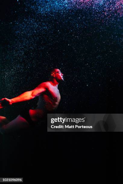 man arising in pool - merman stock pictures, royalty-free photos & images