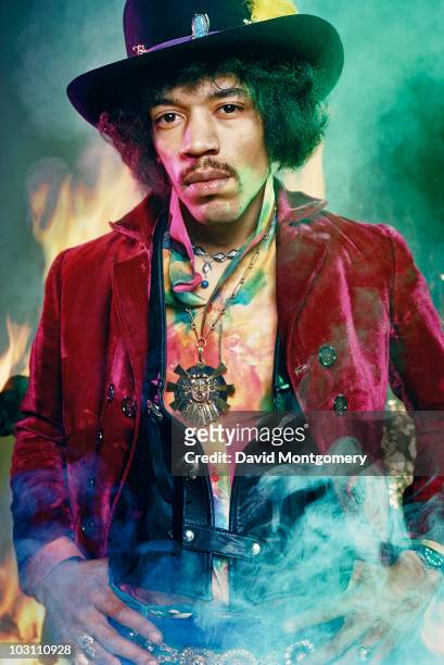 Jimi Hendrix photographed amid smoke and flames for his album 'Electric Ladyland', London, 1968.