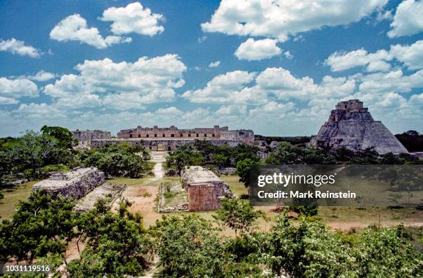 View looking north from the Governor's Palace towards the Nunnery and the Ball Court with the Pyramid of the Magician on the right, at Uxmal,...