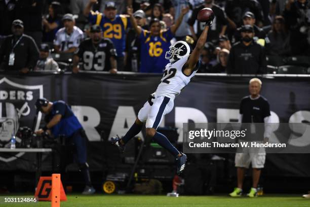 Marcus Peters of the Los Angeles Rams dives into the endzone after an interception of Derek Carr of the Oakland Raiders in the fourth quarter of...