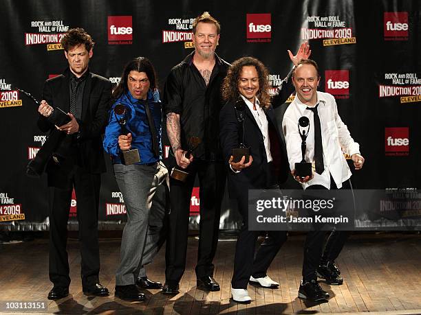 Musicians Jason Newsted with Robert Trujillo, James Hetfield and Kirk Hammett, Lars Ulrich of Metallica pose in the press room during the 24th Annual...