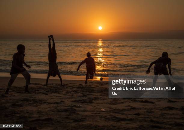 Boys dancing capoeira on the beach at sunset, Benguela Province, Benguela, Angola on July 9, 2018 in Benguela, Angola.