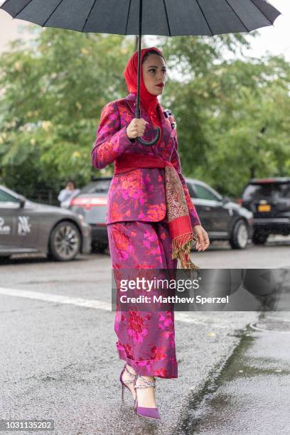 Mademoiselle Meme is seen on the street during New York Fashion Week SS19 wearing floral pattern pink/red suit with red silk head scarf on September...