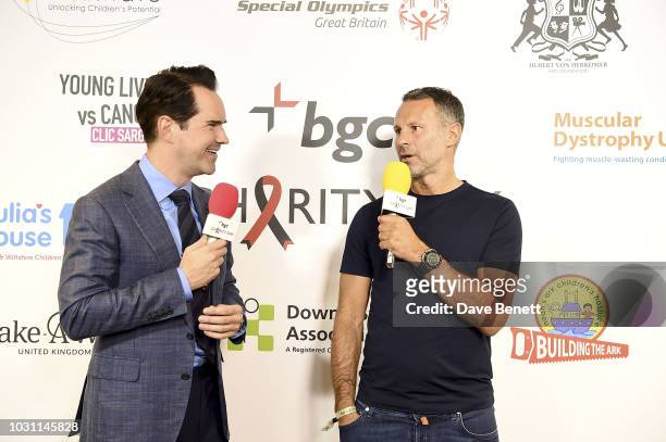 Jimmy Carr and Ryan Giggs make a trade at the BGC Charity Day at One Churchill Place on September 11, 2018 in London, England.