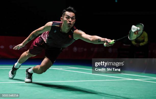 Lin Dan of China competes in the Men's Singles first round match against Kantaphon Wangcharoen of Thailand on day one of the Yonex Japan Open at...