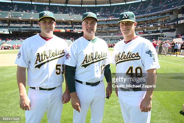 American League All-Star Trevor Cahill and Andrew Bailey of the Oakland Athletics along with Athletics manager Bob Geren stand on the field prior to...
