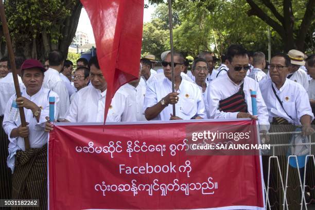 Supporters of Myanamr military including retired military personnel display a banner denouncing facebook's alleged political meddling during a rally...