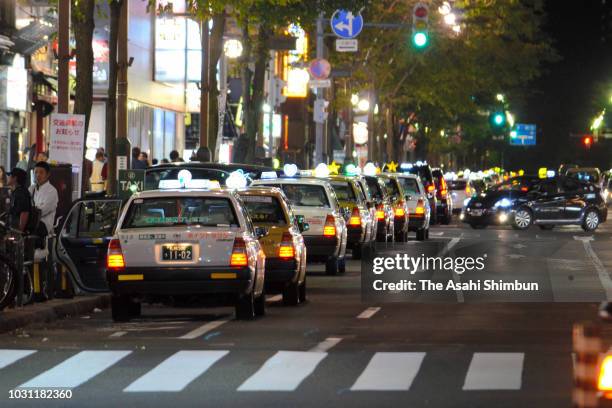 Taxis queue while waiting for customers at Susukino district on September 11, 2018 in Sapporo, Hokkaido, Japan. A male resident in Atsuma who was the...