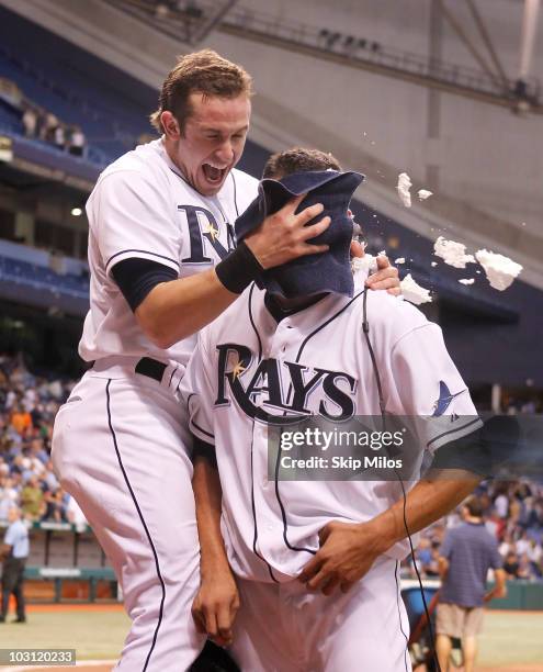 Evan Longoria of the Tampa Bay Rays pushes a shaving cream pie into the face of teammate Matt Garza in celebration of Garza pitching a no-hitter in...