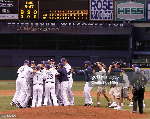 Matt Garza of the Tampa Bay Rays is surrounded by his teammates in celebration of Garza pitching a no-hitter in the Rays' 5-0 win against the Detroit...