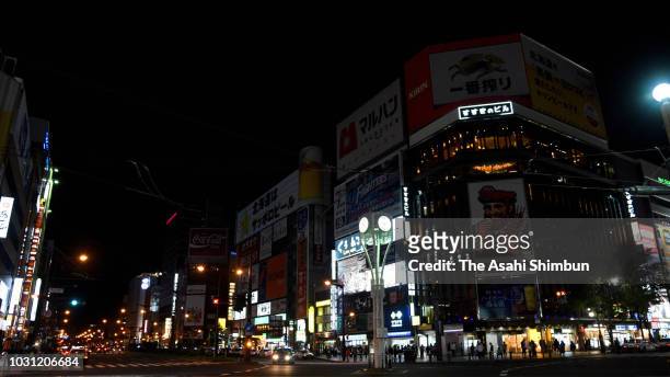 Electric boards are not turned on at Susukino district in attempt to save energy on September 10, 2018 in Sapporo, Hokkaido, Japan. Commuters hit the...