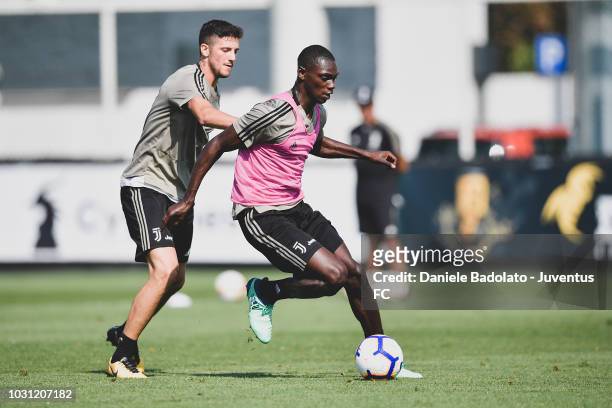 Juventus players Simone Emmanuello and Idrissa Toure during a training session at JTC on September 11, 2018 in Turin, Italy.