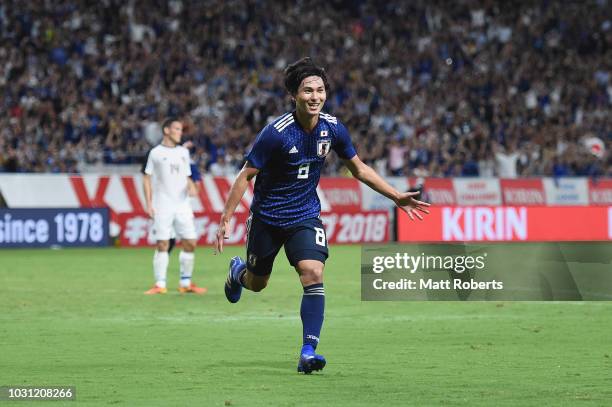 Takumi Minamino of Japan celebrates scoring a goal during the international friendly match between Japan and Costa Rica at Suita City Football...