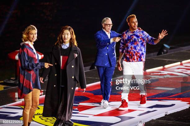 American fashion designer Tommy Hilfiger of Tommy Hilfiger Corporation, British racing driver Lewis Hamilton and model Hailey Baldwin walk the runway...