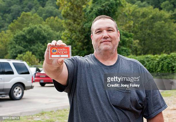 Flood victim, Bobby Mullins shows us the tag he needs to pick up his clean clothes after dropping them off at Tide's Loads Of Hope mobile laundry...