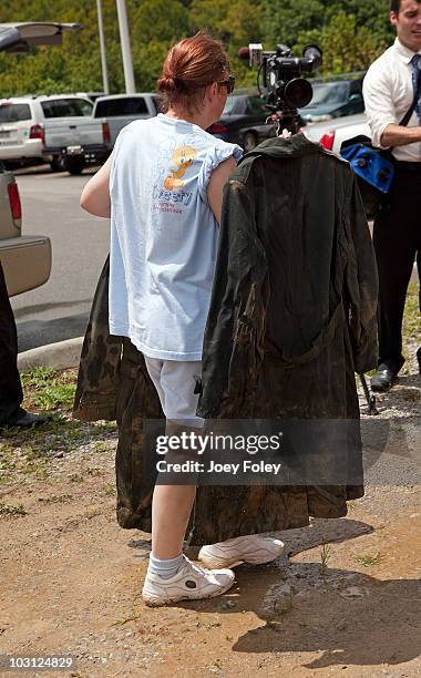 Flood victim drops off a soldier's uniforms to get cleaned at the Tide's Loads Of Hope mobile laundry program at the Loads of Hope truck laundry...