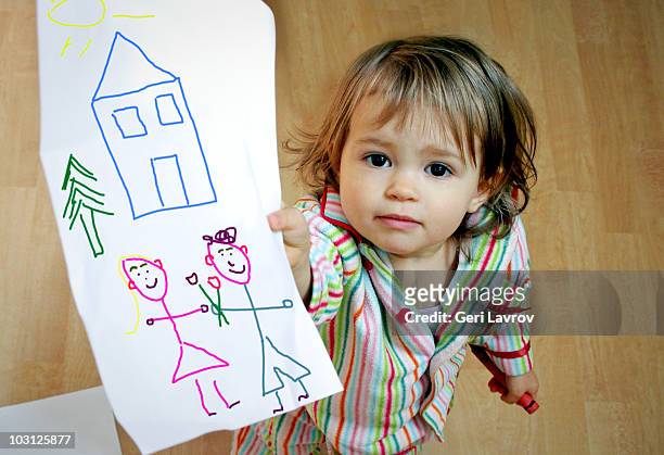 one year old girl holding a drawing - one baby girl only stock pictures, royalty-free photos & images