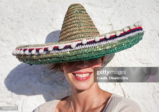 young woman wearing sombrero hat - hat sombrero stock-fotos und bilder