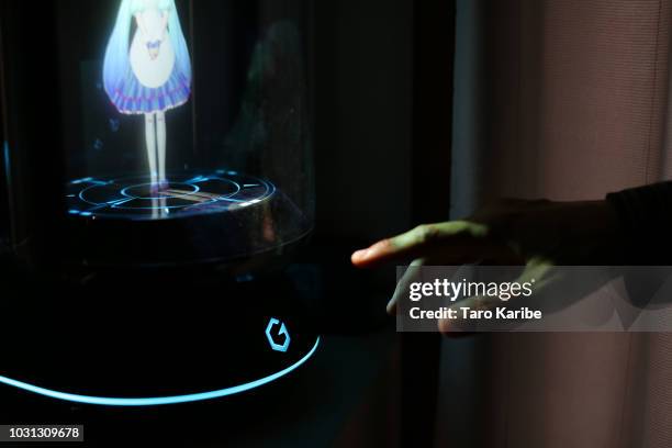 Akihiko Kondo pushes the home button on the 'Gatebox' to communicate with 'Hatsune Miku' at his house on September 11, 2018 in Tokyo, Japan. Akihiko...