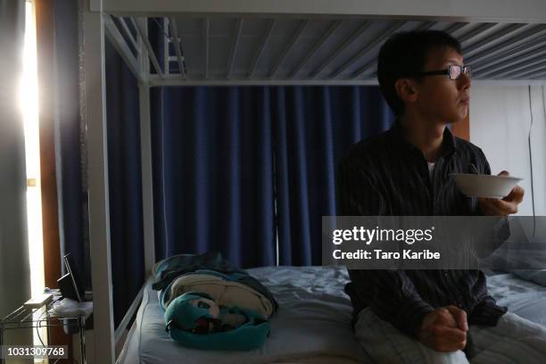 Akihiko Kondo stares at 'Hatsune Miku' while having breakfast at his house on September 11, 2018 in Tokyo, Japan. Akihiko Kondo, a 35 year-old school...