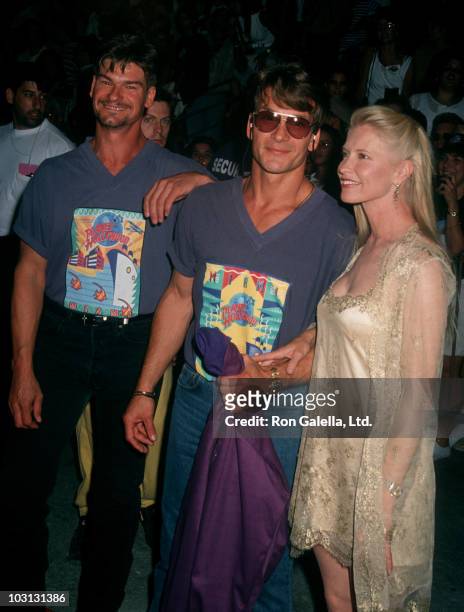 Actors Don Swayze and Patrick Swayze and wife Lisa Niami attend the grand opening of Planet Hollywood on May 15, 1994 in Miami, Florida.