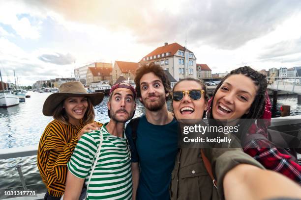 group of friends taking a selfie in copenhagen and making funny faces - copenhagen tourist stock pictures, royalty-free photos & images