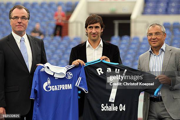 Chairman Clemens Toennies, Raul Gonzalez and head coach Felix Magath of Schalke present the new jersey during the FC Schalke press conference at the...