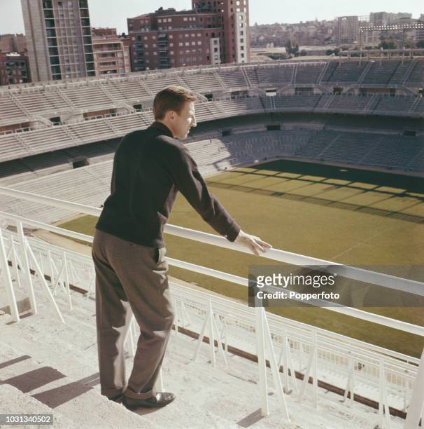 Welsh footballer Cliff Jones, left winger with Tottenham Hotspur, pictured looking down on to the pitch from the top tier of the stands at Real...