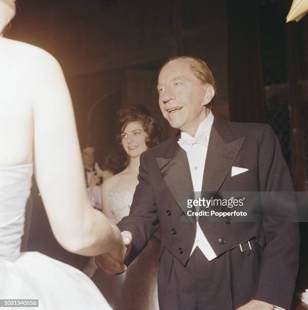 American born industrialist J Paul Getty , founder of the Getty Oil Company, pictured greeting guests arriving for a party at his recently acquired...
