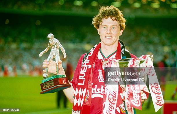 Steve McManaman of Liverpool is man of the match, and holds his award in his right hand, and the Coca-Cola Cup League Cup trophy in his left,...