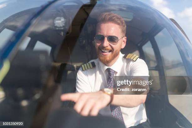 close-up of pilot in helicopter cockpit - helicopter pilot stock pictures, royalty-free photos & images