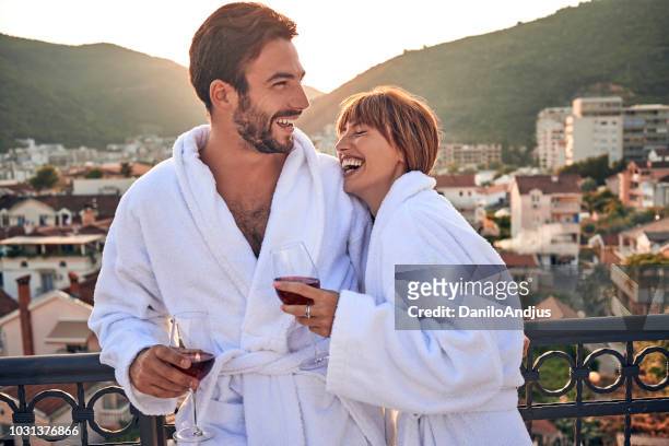 beautiful young couple chatting and enjoying together - hotel balcony stock pictures, royalty-free photos & images