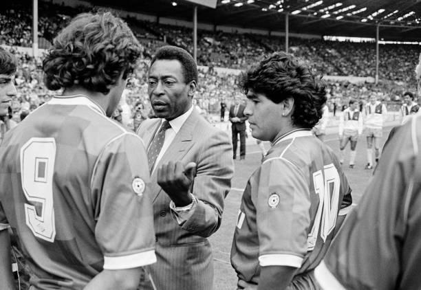 Special guest of honour Pele speaking to Michel Platini as Diego Maradona listens in prior to the Football League Centenary match between the...